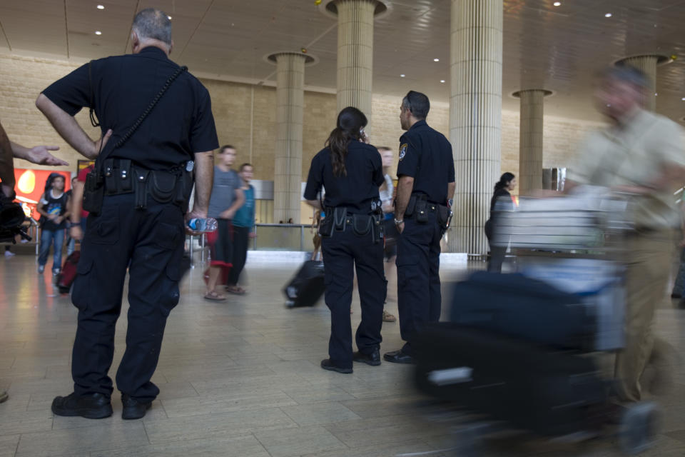 FILE - In this Thursday, July 7, 2011 file photo, Israeli police officers stand guard at Ben Gurion international airport near Tel Aviv , Israel. In a modern twist on Israel's vaunted history of airport security, the country has begun forcing incoming travelers deemed suspicious to open their personal e-mail accounts for inspection. (AP Photo/Ariel Schalit, File)