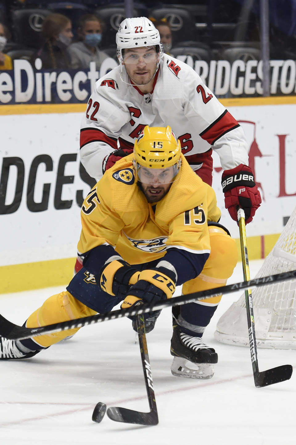 Nashville Predators right wing Brad Richardson (15) reaches for the puck in front of Carolina Hurricanes defenseman Brett Pesce (22) during the second period of an NHL hockey game Saturday, May 8, 2021, in Nashville, Tenn. (AP Photo/Mark Zaleski)