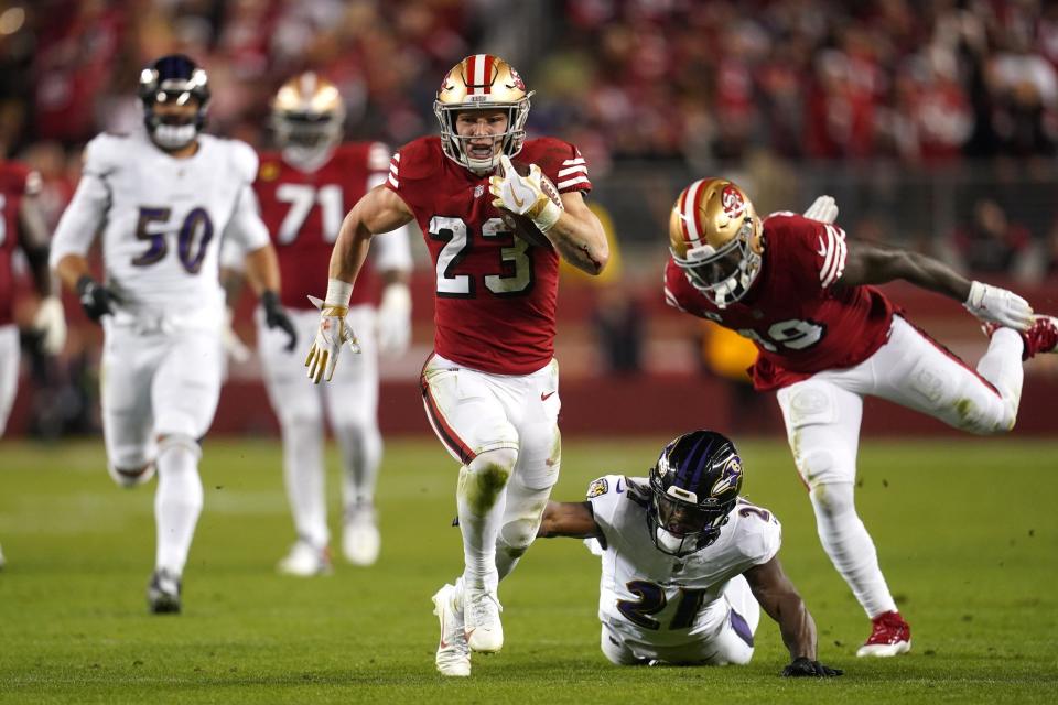 Dec 25, 2023; Santa Clara, California, USA; San Francisco 49ers running back Christian McCaffrey (23) runs the ball pressured by Baltimore Ravens cornerback Brandon Stephens (21) in the second quarter at Levi's Stadium. Mandatory Credit: Cary Edmondson-USA TODAY Sports