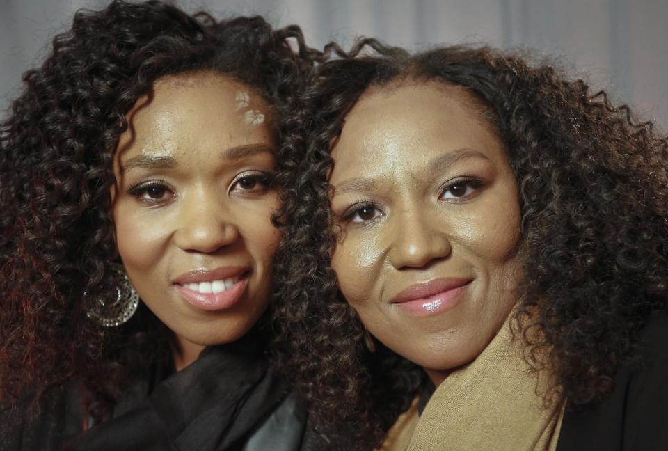 In this Wednesday, Feb. 6, 2013 photo, Swati Dlamini, left, and Zaziwe Dlamini-Manaway, granddaughters of Nelson and Winnie Mandela, pose during an interview in New York. The sisters are stars of the new reality show "Being Mandela," produced by COZI TV for NBC. The 30-minute weekly show premieres on Sunday, Feb. 10 at 9 PM ET and will follow the next generation of Mandela family through the experiences of sisters Zaziwe and Swati and their families. (AP Photo/Bebeto Matthews)