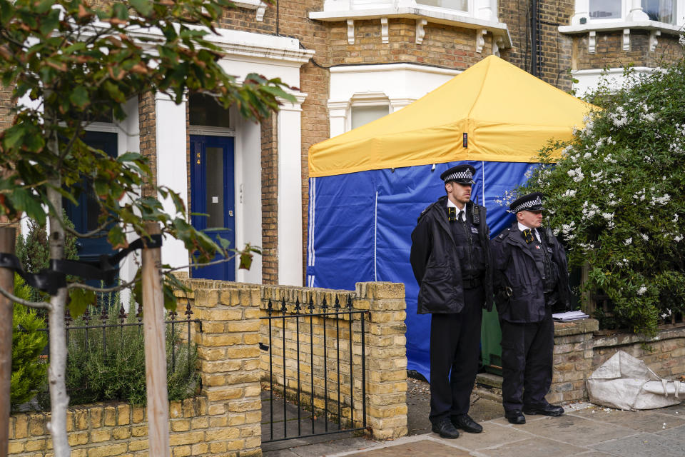 Police officers stand outside a house in north London, thought to be in relation to the death of Conservative MP Sir David Amess, Sunday, Oct. 17, 2021. Leaders from across Britain's political spectrum have come together to pay tribute to a long-serving British lawmaker who was stabbed to death in what police have described as a terrorist attack. (AP Photo/Alberto Pezzali)