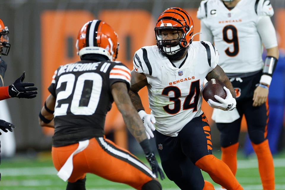 Bengals running back Samaje Perine carries the ball with Browns cornerback Greg Newsome II defending during the first half in Cleveland, Monday, Oct. 31, 2022.