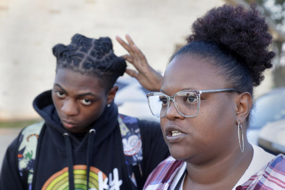 Darryl George, left, a 17-year-old junior, and his mother Darresha George, right, talks with reporters before walking across the street to go into Barbers Hill High School after Darryl served a 5-day in-school suspension for not cutting his hair Monday, Sept. 18, 2023, in Mont Belvieu. (AP Photo/Michael Wyke)