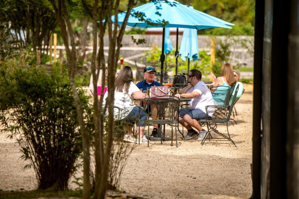 Customers enjoy good company and cold beer at Gary's Brewery and Biergarten Sunday, April 2, 2023.