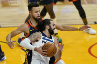 Minnesota Timberwolves guard Ricky Rubio, foreground, drives against Golden State Warriors guard Stephen Curry during the first half of an NBA basketball game in San Francisco, Wednesday, Jan. 27, 2021. (AP Photo/Jeff Chiu)