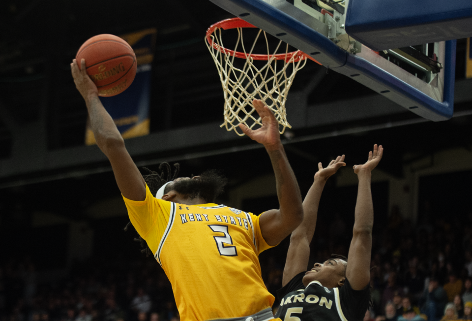 Kent State's Reggie Bass (left) takes a shot with Akron's Tavari Johnson on defense during Friday's game.