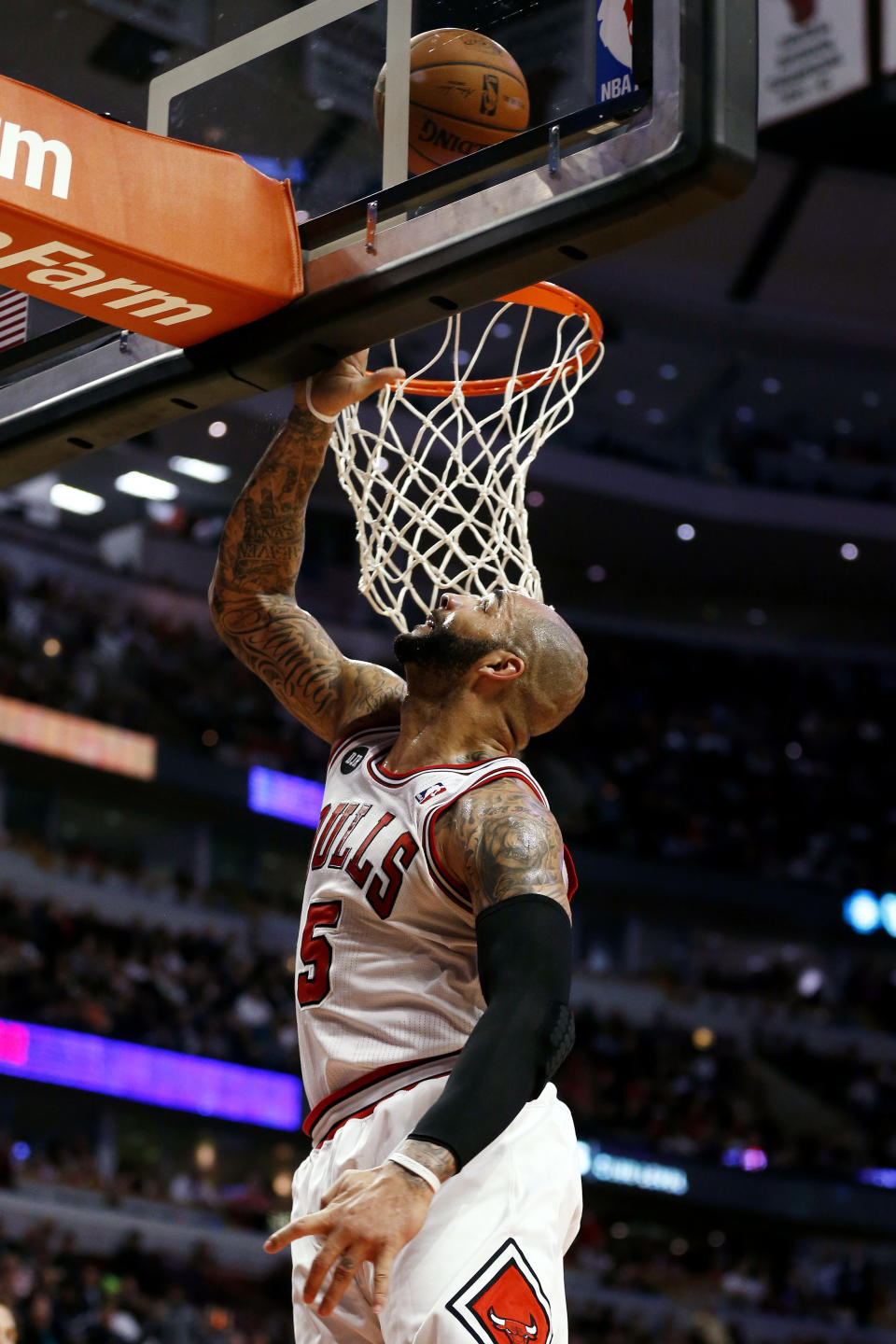 Chicago Bulls power forward Carlos Boozer (5) scores a basket against the San Antonio Spurs during the second half of an NBA basketball game on Tuesday, March 11, 2014, in Chicago. The San Antonio Spurs defeated The Chicago Bulls 104-96. (AP Photo/Andrew A. Nelles)