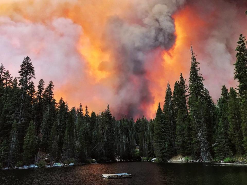 Smoke from the Creek Fire billows beyond a ridge as seen from Huntington Lake on Saturday, Sept. 5, 2020.