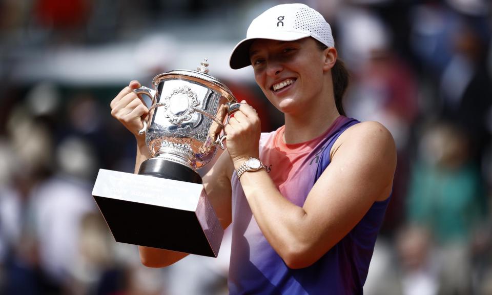 <span>Iga Swiatek poses with the trophy after defeating Jasmine Paolini to win the French Open.</span><span>Photograph: Yoan Valat/EPA</span>