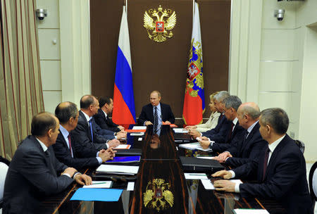 Russian President Vladimir Putin (C) chairs a meeting with members of the Security Council at the Bocharov Ruchei state residence in Sochi, Russia, May 13, 2016. Mikhail Klimentyev/Sputnik/Kremlin via Reuters