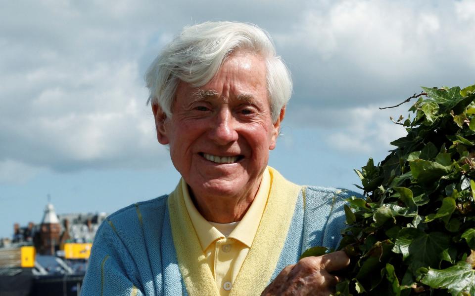 Former professional golfer Doug Sanders of the U.S. poses for a photograph following an interview with Reuters - REUTERS