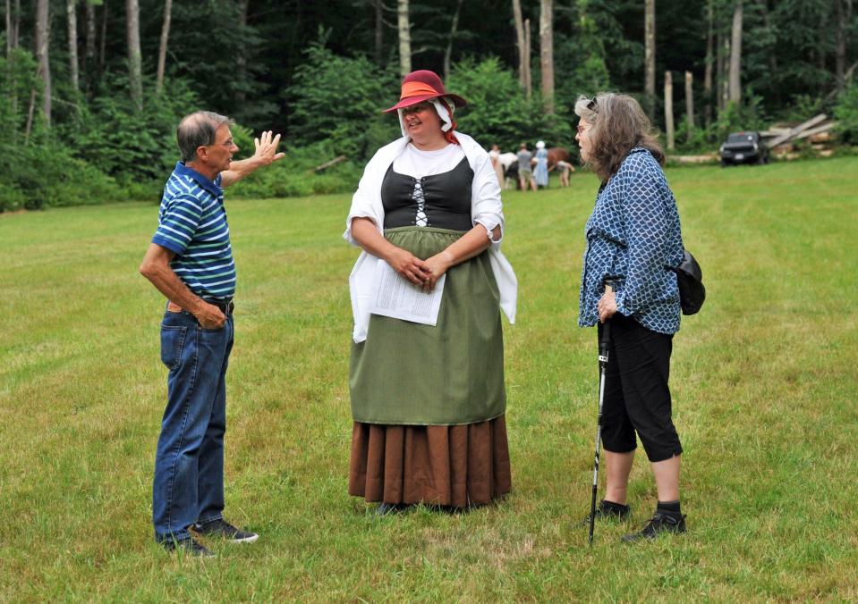 Rebecca Lambert, center, of Norwell, dressed in Colonial costume, discusses the founder of Norwell, Cornet Robert Stetson, with George Gilman, of Norwell, left, and Janet Spongberg, of Norwell, during Stetson Norwell Heritage Day, Saturday, Aug. 19, 2023.