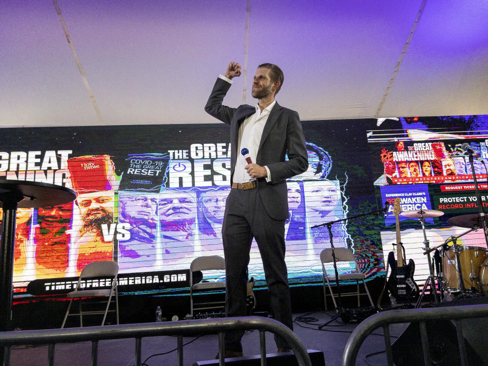 Eric Trump, son of former President Donald Trump, raises a fist as he arrives to speak on stage during the ReAwaken America Tour at Cornerstone Church in Batavia, N.Y., Friday, Aug. 12, 2022. (AP Photo/Carolyn Kaster)