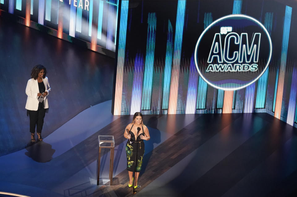 Maren Morris accepts the female artist of the year award as presenter CeCe Winans, left, looks on during the 55th annual Academy of Country Music Awards at the Grand Ole Opry House on Wednesday, Sept. 16, 2020, in Nashville, Tenn. (AP Photo/Mark Humphrey)