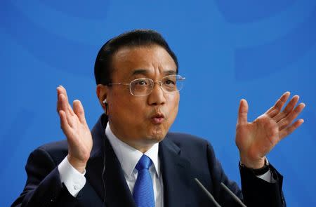 Chinese Prime Minister Li Keqiang gestures as he holds a joint news conference with German Chancellor Angela Merkel (not pictured) at the chancellery in Berlin, Germany, July 9, 2018. REUTERS/Fabrizio Bensch