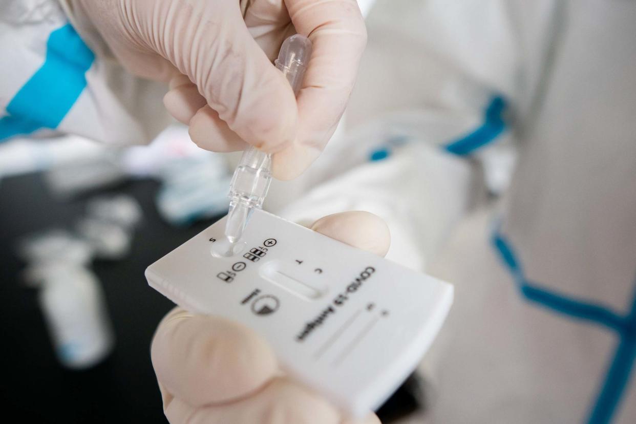 A health worker in protective clothes evaluates a Covid-19 antigen test on the novel coronavirus on September 23, 2020 in Vienna, on the sidelines of the Austrian Media Days: APA/AFP via Getty Images