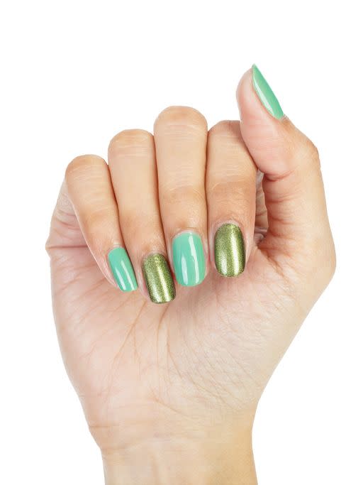 women hands with nail manicure in alternating colors of green