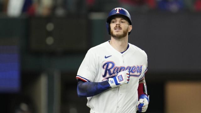 Texas Rangers catcher Jonah Heim reacts after striking out during