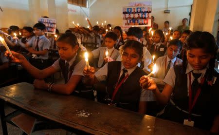 School girls hold candles during a vigil for the soldiers who were killed in Sunday’s attack at an Indian army base in Kashmir's Uri, in Ahmedabad, India, September 20, 2016. REUTERS/Amit Dave