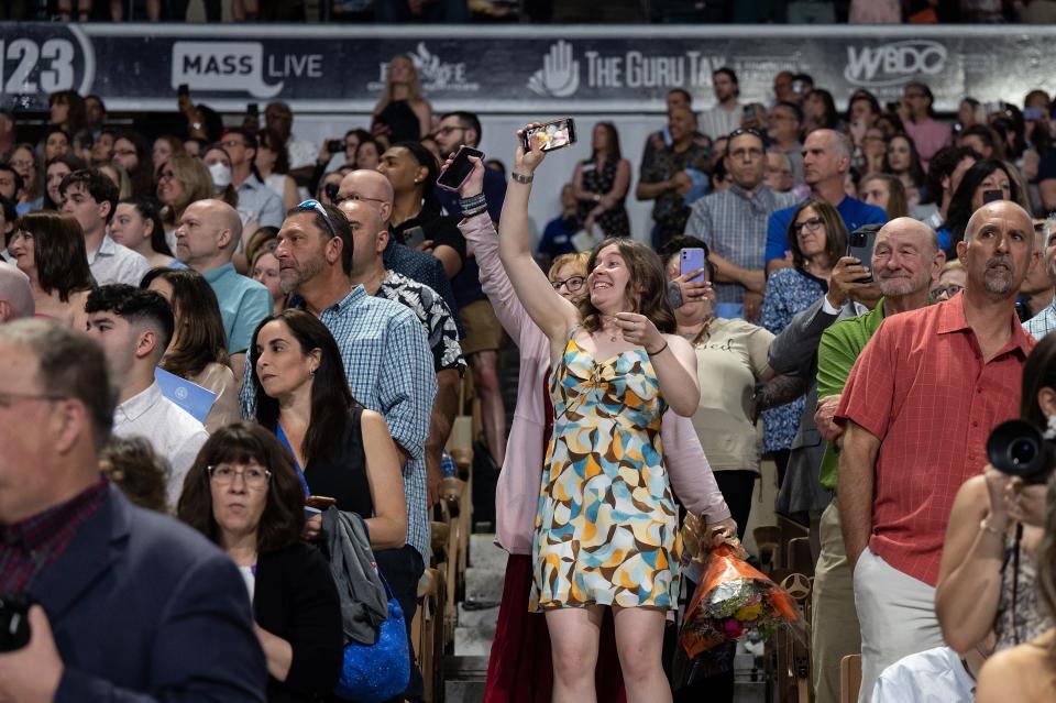 Guests cheer during the processional at Worcester State University's 2023 Spring Commencement at the DCU Center Saturday.