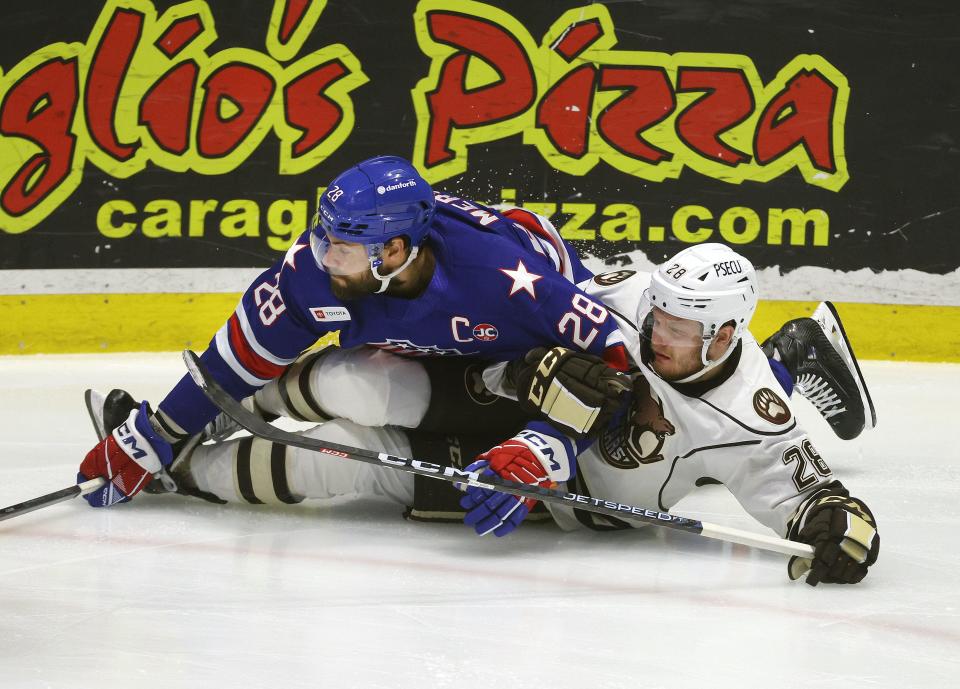 Amerks Michael Mersch and Hershey’s Ethen Frank go to the ice during Game 4 of the Calder Cup Eastern Conference Finals.