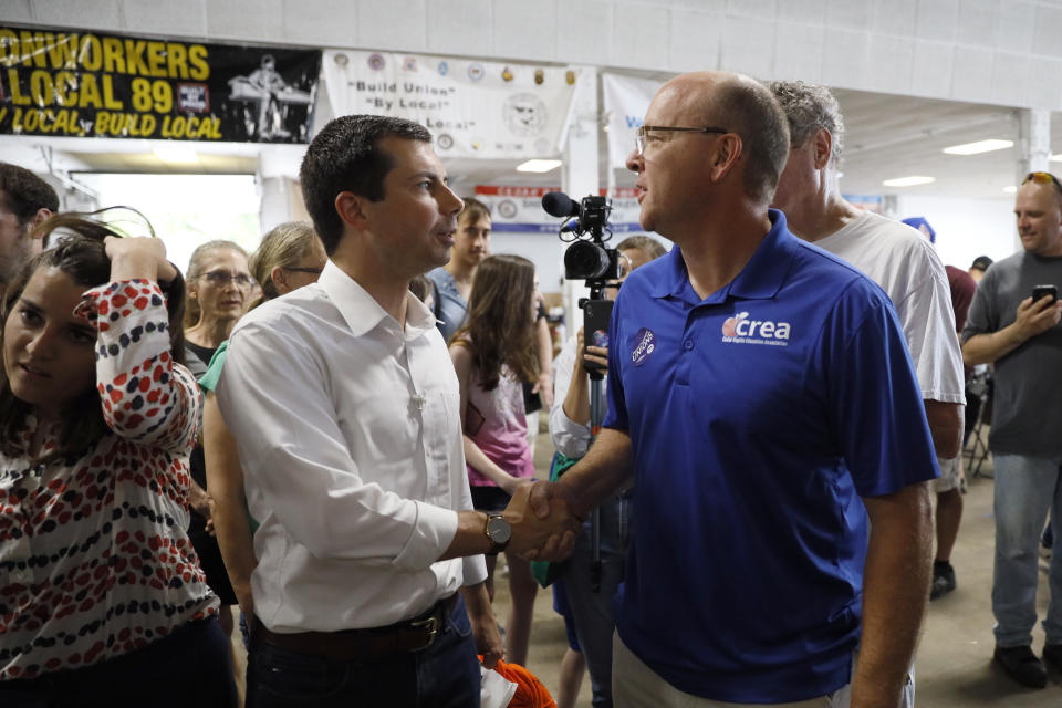 Democratic presidential candidate Pete Buttigieg talks with Chris Rolwes, of Cedar Rapids, Iowa, right, during the Hawkeye Area Labor Council Labor Day Picnic, Monday, Sept. 2, 2019, in Cedar Rapids, Iowa. (AP Photo/Charlie Neibergall)