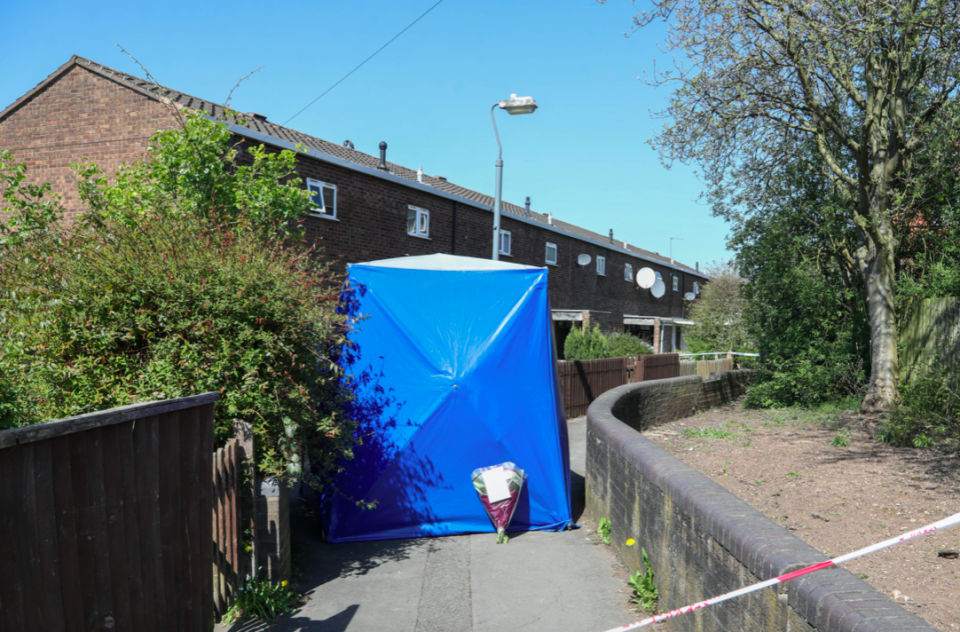 Flowers lie at the scene where the arson attack on Peggy Wright's home took place. (SWNS)