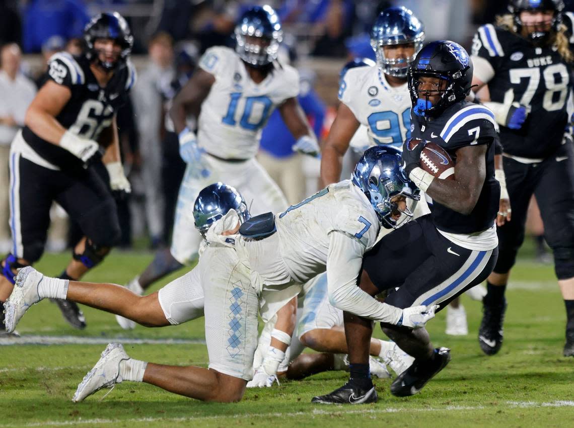 Duke Blue Devils running back Jordan Waters is tackled by North Carolina Tar Heels linebacker Noah Taylor during the second half of Saturday’s game at Wallace Wade Stadium in Durham, N.C.