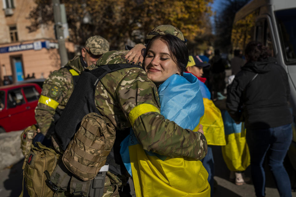 A Kherson resident hugs a Ukrainian defence force member in Kherson, southern Ukraine, Monday, Nov. 14, 2022. The retaking of Kherson was one of Ukraine's biggest successes in the nearly nine months since Moscow's invasion. (AP Photo/Bernat Armangue)