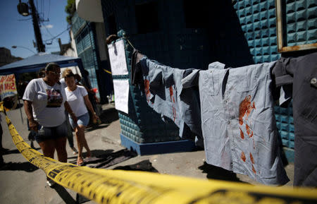 Uniforms placed by family members of police officers in protest for better salaries, are pictured in front of the entrance of the military police battalion in Rio de Janeiro, Brazil February 10, 2017. REUTERS/Ricardo Moraes