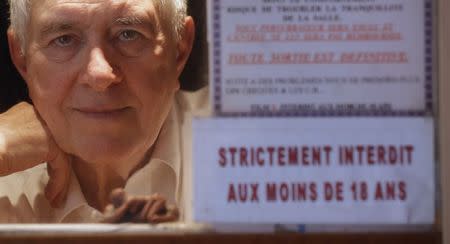 Maurice Laroche, owner of Le Beverley adult cinema, poses inside his cinema in Paris July 30, 2014. REUTERS/Christian Hartmann