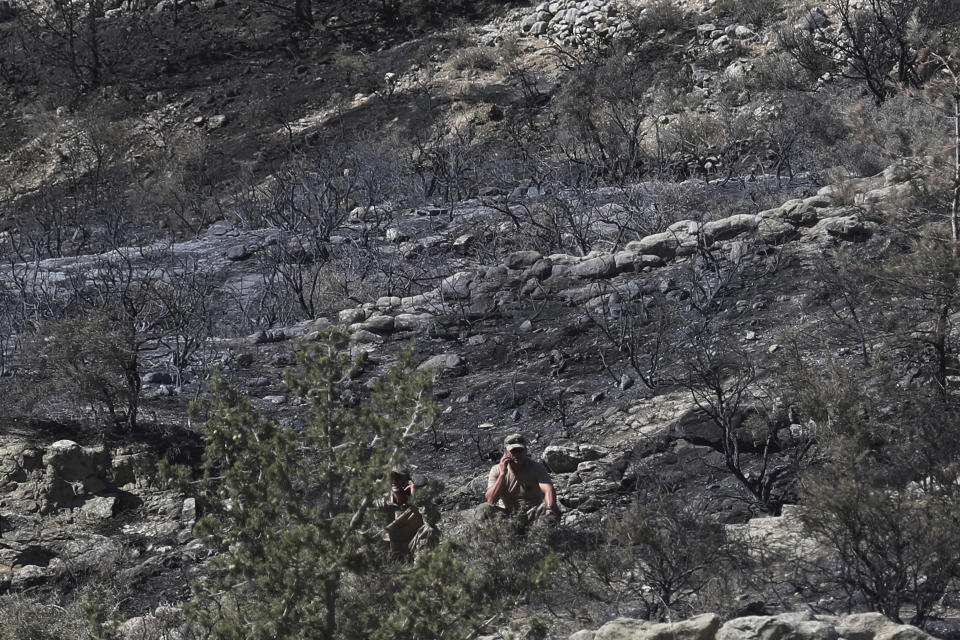 Turkish soldiers patrol the area after an explosion pre-dawn, outside of village of Tashkent in Turkish Cypriot breakaway north part of the divided Cyprus, Monday, July 1, 2019. A Turkish Cypriot official said Monday that a Syrian anti-aircraft missile that missed its target and reached ethnically divided Cyprus may have been the cause of an explosion outside a village in east Mediterranean island notion's breakaway north. No injuries were reported. (AP Photo/Petros Karadjias)