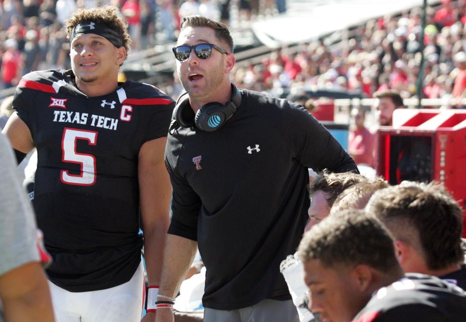 Texas Tech head coach Kliff Kingsbury and quarterback Patrick Mahomes watch a replay on the video board during a game against West Virginia.