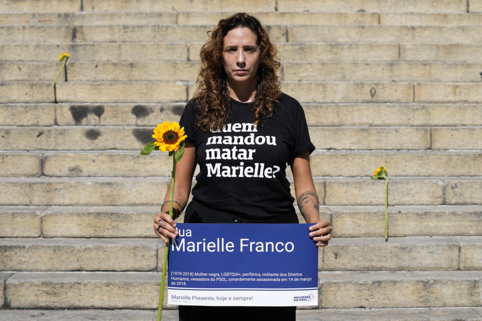 FILE - Monica Benicio, the widow of slain councilwoman Marielle Franco, wears a T-shirt with the mantra that reads in Portuguese: "Who Killed Marielle", during a tribute to Franco on the sixth anniversary of her assassination outside City Hall, in Rio de Janeiro, Brazil, March 14, 2024. (AP Photo/Silvia Izquierdo, File)