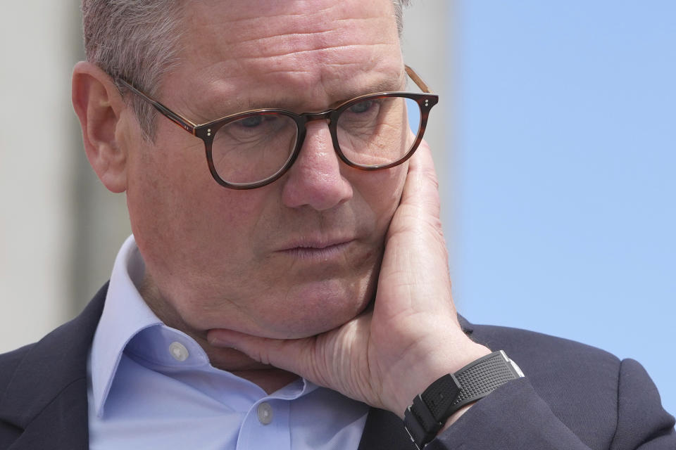 FILE - Labour Party leader Keir Starmer listens to a question from port workers during a general election campaign event Southampton Docks in Southampton, England, Monday, June 17, 2024. The United Kingdom will hold its first national election in almost five years on Thursday, with opinion polls suggesting that Prime Minister Rishi Sunak’s Conservative Party will be punished for failing to deliver on promises made during 14 years in power. (AP Photo/Kin Cheung, File)