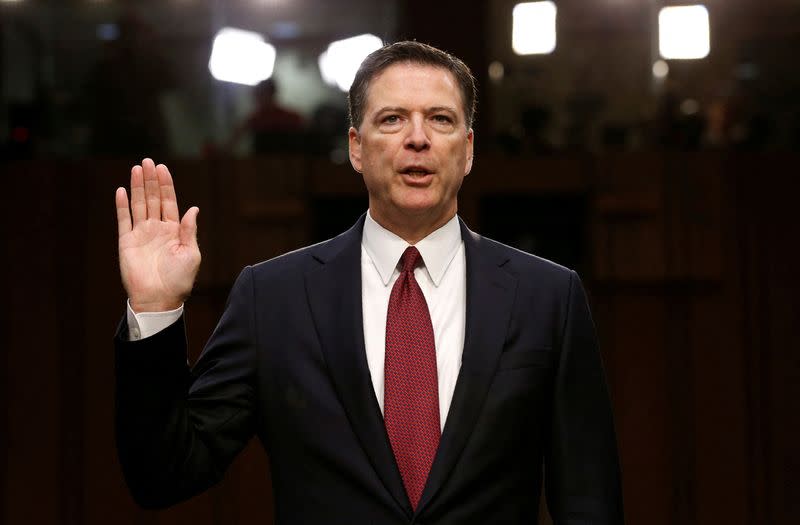 FILE PHOTO: Former FBI Director James Comey sworn in to testify at a hearing in Washington