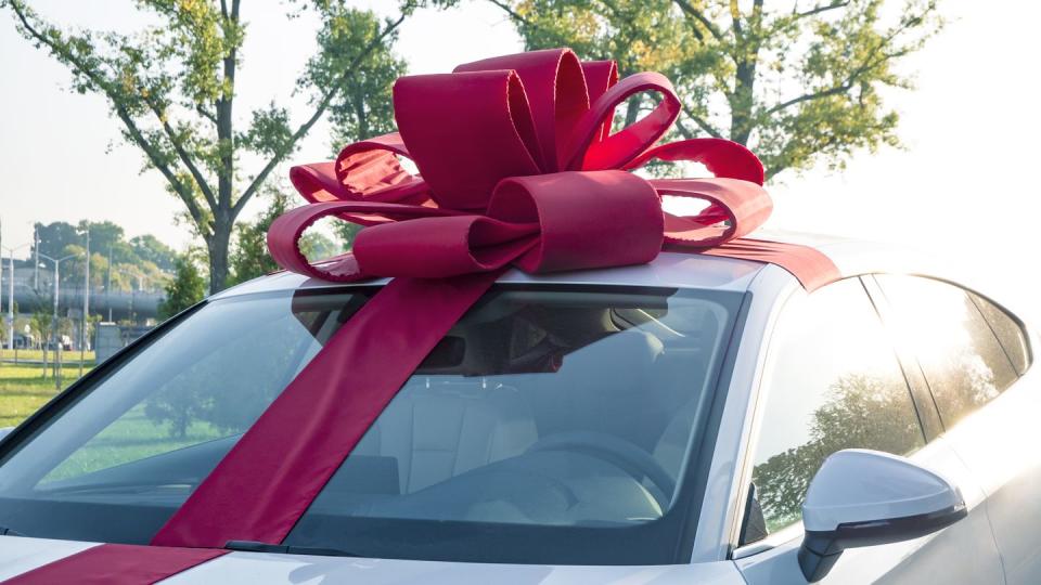 new car gift new white car with red gift ribbon
