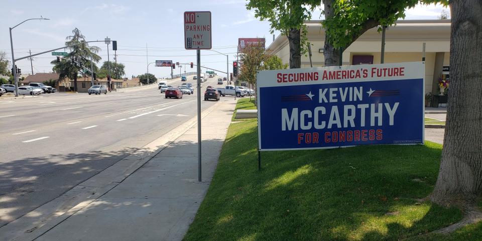 A large sign endorsing Kevin McCarthy for Congress along a main strip of road in Bakersfield