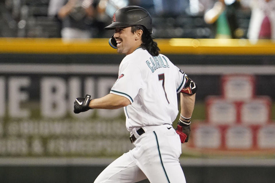 Arizona Diamondbacks' Corbin Carroll runs away from teammates after he drove in two runs with a single against the Colorado Rockies during the ninth inning of a baseball game Thursday, June 1, 2023, in Phoenix. Arizona won 5-4. (AP Photo/Darryl Webb)