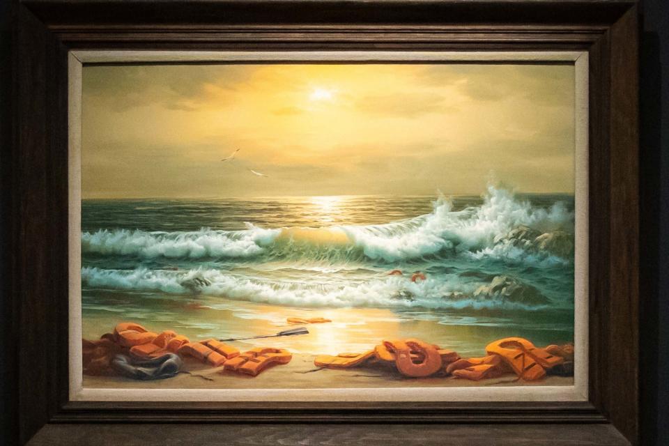 One of three paintings making up the Mediterranean Sea View triptych by Banksy (PA)