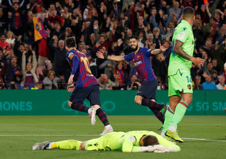 Soccer Football - La Liga Santander - FC Barcelona v Levante - Camp Nou, Barcelona, Spain - April 27, 2019 Barcelona's Lionel Messi celebrates scoring their first goal with Luis Suarez as Levante's Aitor Fernandez looks dejected REUTERS/Albert Gea