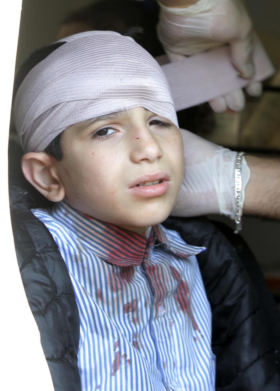 An injured school boy receives treatment inside an ambulance at the site of an explosion near the Iranian cultural centre in the southern suburbs of Beirut February 19, 2014. (REUTERS/Mahmoud Kheir)