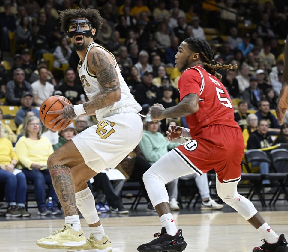 Colorado guard J’Vonne Hadley, left, moves to the basket as Utah guard Devon Smith defends in the first half of an NCAA college basketball game Saturday, Feb, 24, 2024, in Boulder, Colo. | Cliff Grassmick, Associated Press