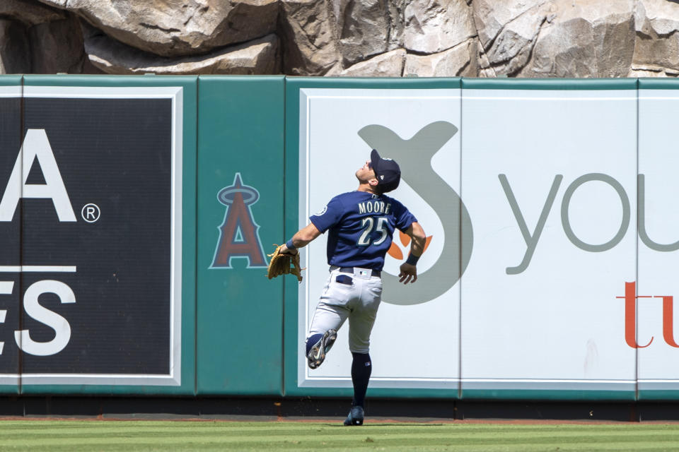 Seattle Mariners center fielder Dylan Moore looks up to watch Los Angeles Angels' Luis Rengifo's two-run home run during the third inning of a baseball game in Anaheim, Calif., Sunday, Sept. 18, 2022. (AP Photo/Alex Gallardo)