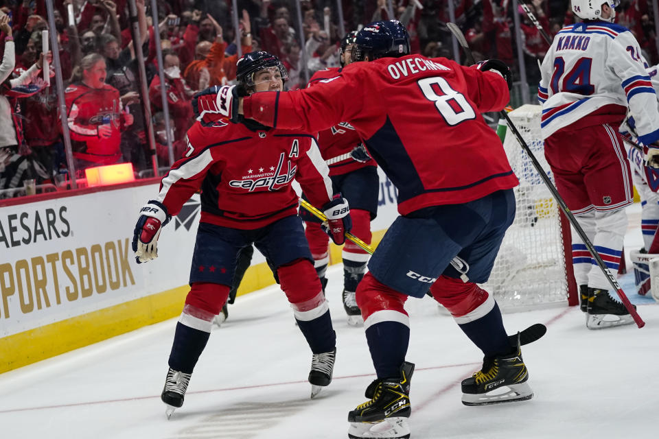 Washington Capitals right wing T.J. Oshie, left, celebrates with left wing Alex Ovechkin after Oshie's goal against the New York Rangers during the first period of an NHL hockey game Wednesday, Oct. 13, 2021, in Washington. (AP Photo/Alex Brandon)