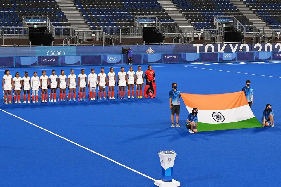 Players of India listen to their national anthem before the women's semi-final match of the Tokyo 2020 Olympic Games field hockey competition against Argentina, at the Oi Hockey Stadium in Tokyo, on August 4, 2021.