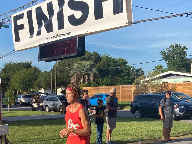 Menendez High School senior runner Ryan Jones crosses the finish line as the overall winner of the Bridge of Lions 5K on Saturday, July 9, 2022, in St. Augustine.