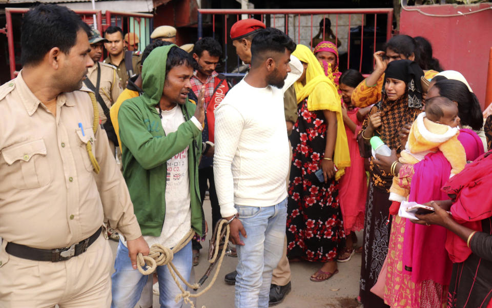 Siddique Ali, 23, in white shirt, looks at his wife Sonali Begum, second right, 17, after he was picked up by the police, outside a police station in Guwahati, India, Friday, Feb. 3, 2023. Indian police have arrested more than 2,000 men in a crackdown on illegal child marriages in involving girls under the age of 18 a northeastern state. Begum is seven months pregnant. (AP Photo)