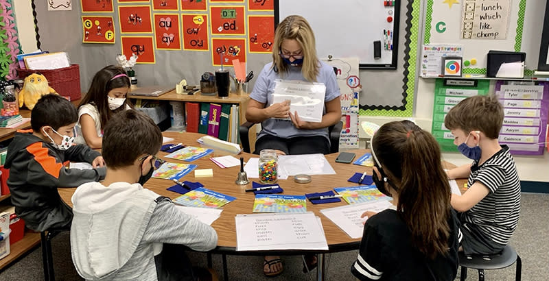 Katie Stidham, a first-grade teacher at Shull Elementary in the Bonita Unified School District, provides reading instruction in a small group. Bonita ranked first in a “report card” on how well districts are preparing disadvantaged Latino third-graders to read. (Bonita Unified School District)