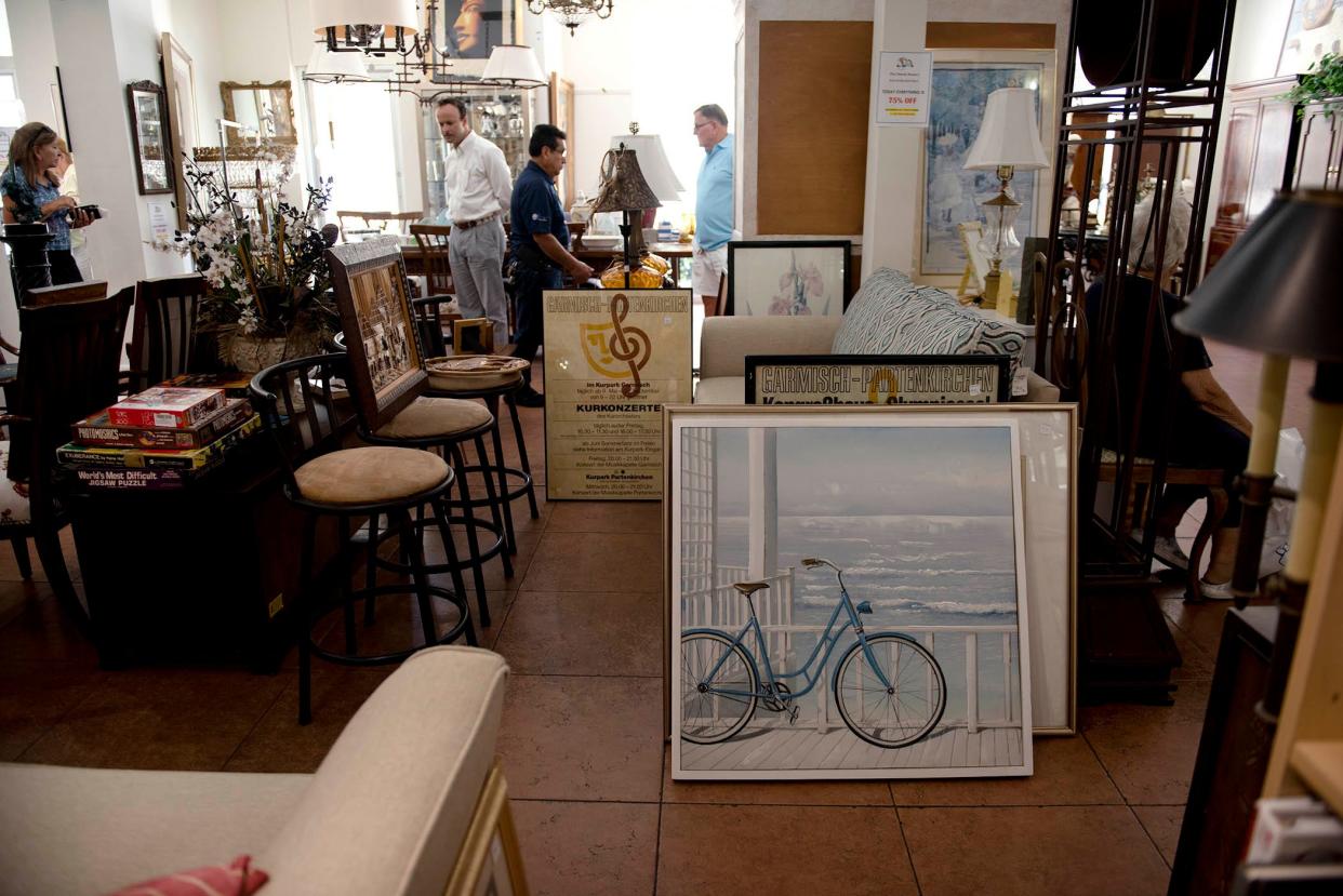 Volunteers and shoppers browse through stock during the annual sale before closing for the summer at The Church Mouse on June 23. The store will reopen Monday for the season.